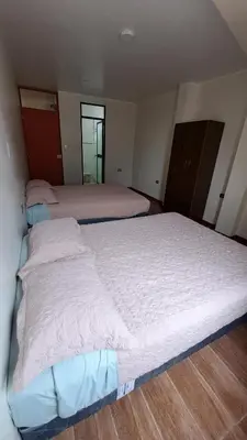 a small bedroom with two beds in it at Habitaciones en la Casa de Dora, 4to y 5to piso in Ayacucho