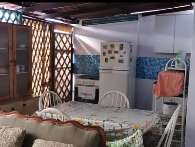 a kitchen with a table and a stove and a refrigerator at Hospedaje interno surco in Lima