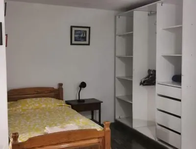 a bedroom with a bed and a book shelf at Hospedaje interno surco in Lima