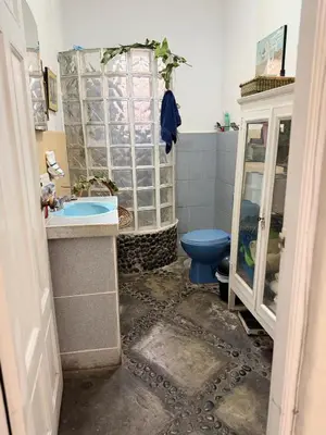 a bathroom with a blue toilet and a sink at Miraflores Moonlight B&B in Lima