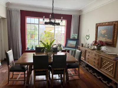 a dining room with a wooden table and chairs at Miraflores Moonlight B&B in Lima