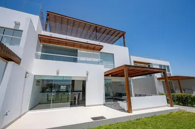 an image of a house with a glass facade at Sotavento Beach Homes by Vibrant in Paracas