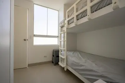 a bedroom with a bunk bed and a window at Sotavento Beach Homes by Vibrant in Paracas