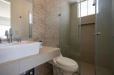 a bathroom with a toilet and a sink and a shower at Sotavento Beach Homes by Vibrant in Paracas