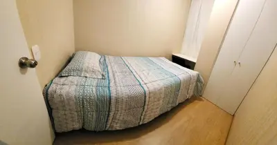 a small bedroom with a bed in a room at TOWEr2 in Lima