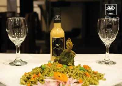 a bottle of wine and a plate of food with wine glasses at Qallwa Chincha in Chincha Alta