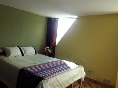 a bedroom with a bed and a window in it at Hostal El Viajero in Surcubamba
