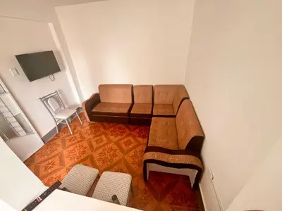 a living room with a couch and a table and chairs at Casa Límaco in Ayacucho