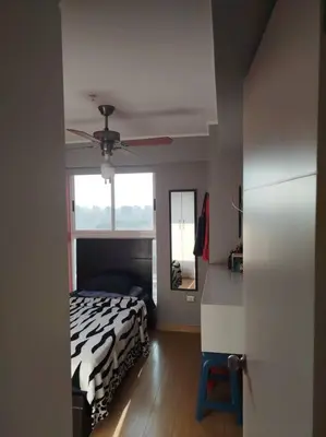 a bedroom with a bed and a ceiling fan at Habitación con baño compartido Santa Catalina in Lima
