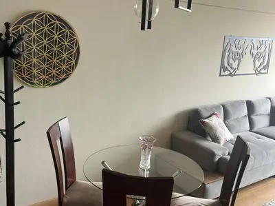 a living room with a glass table and a couch at Habitación con baño compartido Santa Catalina in Lima