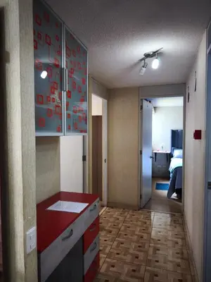 a kitchen with a red counter top in a room at Departamento en Ate in Lima