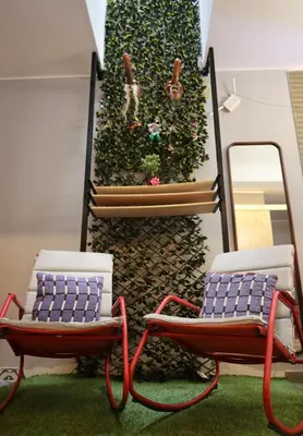 two chairs sitting in front of a wall with a mirror at Casa sabina aeropuerto plus in Lima