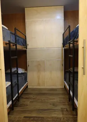 a room with three bunk beds and a door at Casa sabina aeropuerto plus in Lima
