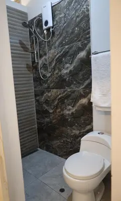 a bathroom with a toilet and a shower at Casa sabina aeropuerto plus in Lima