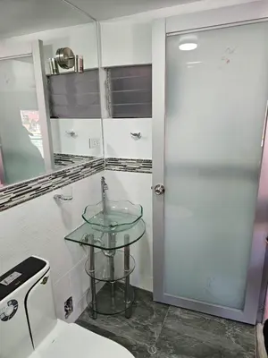 a bathroom with a glass sink and a toilet at Casa Rustica Hostal Paqcha in Cusco