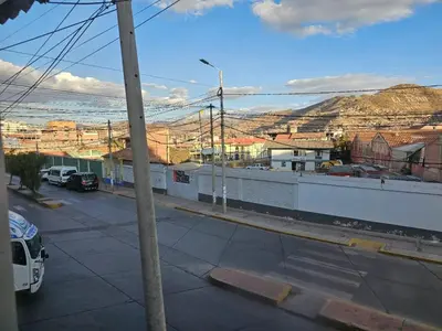 a view of a street with a city and the ocean at Casa Rustica Hostal Paqcha in Cusco
