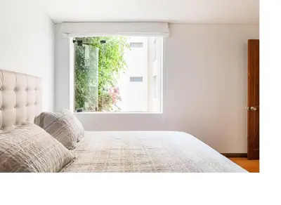 a bedroom with a bed in front of a window at San Borja Pentagonito in Lima