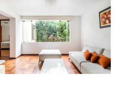 a living room with a couch and a table at San Borja Pentagonito in Lima