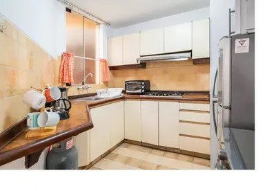 a kitchen with white cabinets and a stainless steel refrigerator at San Borja Pentagonito in Lima