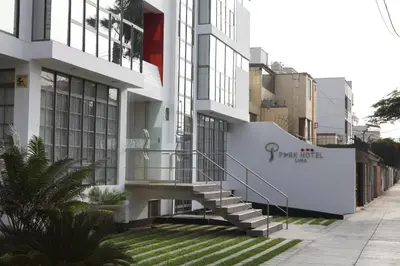 a white building with a staircase on the side of it at Park Hotel Lima in Lima