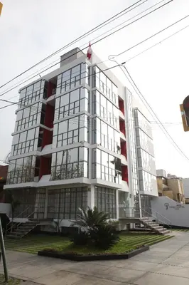 a large white building with a flag on it at Park Hotel Lima in Lima