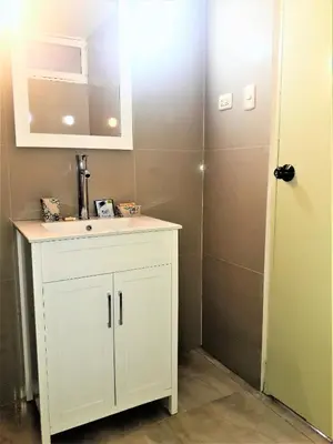 a bathroom with a white cabinet and a sink at Royalty Inn in Lima