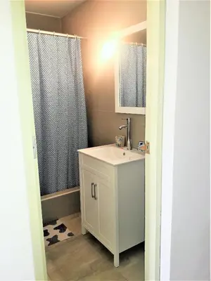 a bathroom with a white sink and a shower at Royalty Inn in Lima