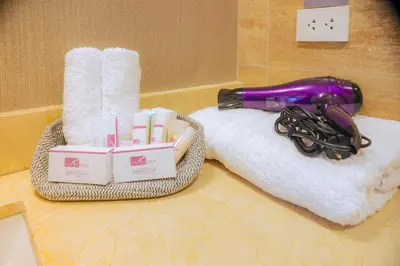 a purple blow dryer sitting on top of a towel at Hotel Andesmar Huancayo in Huancayo