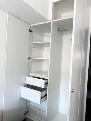 a white closet with white shelves at SAM Apartment Cusco in Cusco
