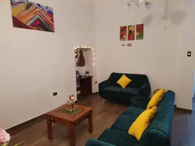 a living room with a couch and a coffee table at Cori Wasi in Cusco
