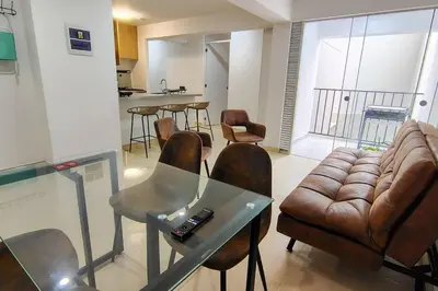 a living room with a glass table and a couch at Departamento en playa Arica in Lurín