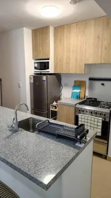 a kitchen with a sink and a counter top at Departamento en playa Arica in Lurín