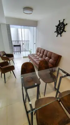 a living room with a couch and a glass table at Departamento en playa Arica in Lurín