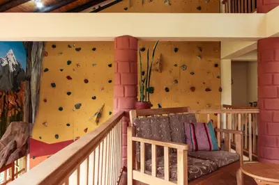 a room with a rock climbing wall with a couch at Spacious entire house with awesome mountain views in Urubamba