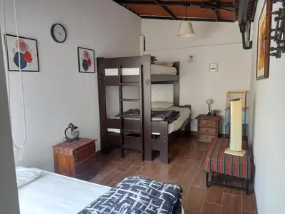 a bedroom with two bunk beds in a room at CASA DE CAMPO CON PISCINA EN COCACHACRA HUAROCHIRI SOL TODO EL AÑo in Cocachacra