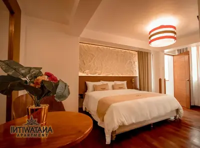 a hotel room with a bed and a table with a table sidx sidx at Intiwatana Apartment in Cusco