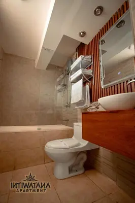 a bathroom with a toilet and a sink and a tub at Intiwatana Apartment in Cusco