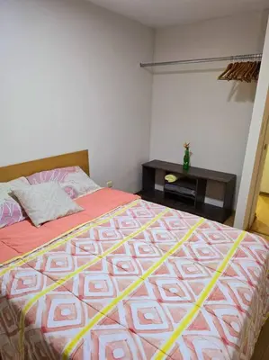 a bedroom with a bed and a table in a room at El Refugio de Katte VI in Lima