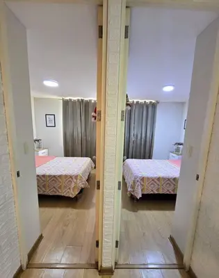 a hallway with two beds in a room at El Refugio de Katte VI in Lima