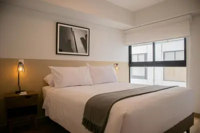 a bedroom with a large white bed with a window at Vital by Wynwood House in Lima