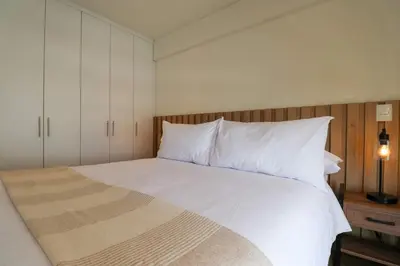 a bedroom with a white bed with white pillows at Aquilaria by Wynwood House in Lima