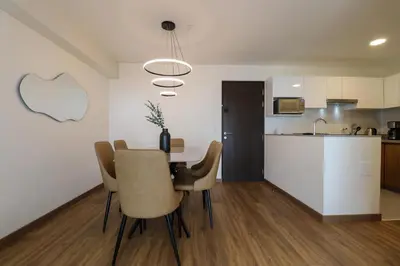 a kitchen and dining room with a table and chairs at Aquilaria by Wynwood House in Lima