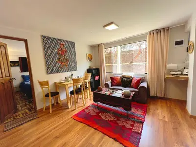 a living room with a couch and a table at boutique guest house art in the center of cusco in Cusco
