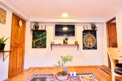 a living room with a tv on a wall at boutique guest house art in the center of cusco in Cusco