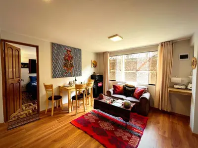a living room with a couch and a table at boutique guest house art in the center of cusco in Cusco