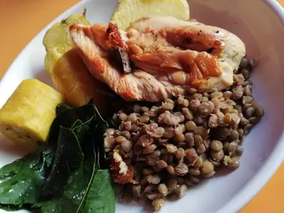 a plate of food with seafood and lentils on it at Hotel Villa Capricce in Puente Piedra