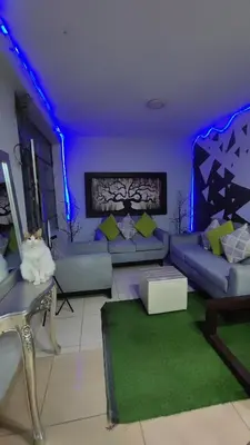 a living room with blue lights and a couch at Hotel Villa Capricce in Puente Piedra
