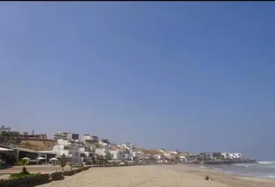 a beach with a bunch of buildings and the ocean at 