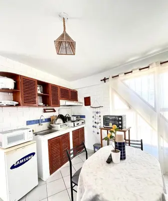 a kitchen with a table and a white appliance at 