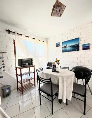 a dining room with a table and chairs and a sink at 
